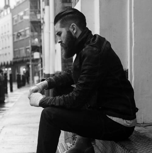 Man with slicked-back hair and a full beard