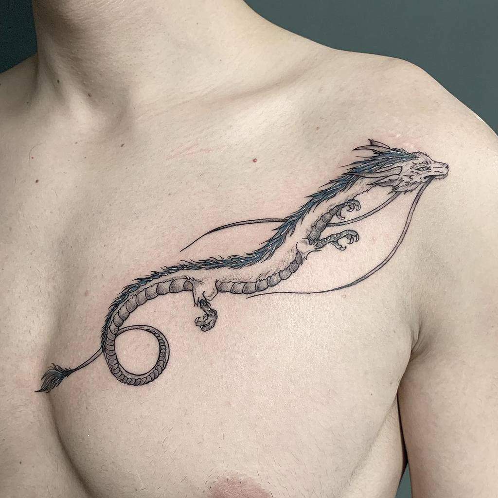 Elegant fine-line tattoo of Haku in dragon form from Spirited Away, with delicate shading and subtle blue accents