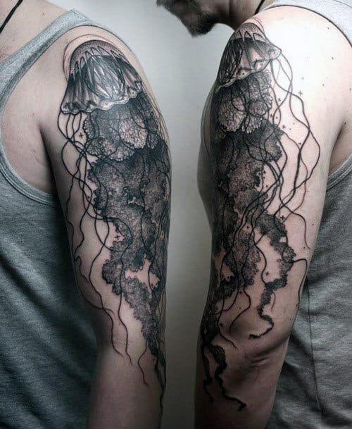 Intricate jellyfish tattoos on an upper arm