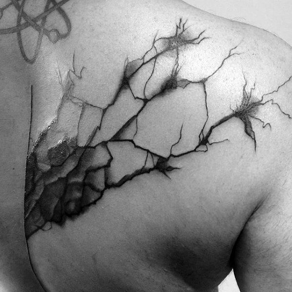 Neuron tattoo on upper back with cracked skin effect, showcasing branching neurons emerging from shaded fractured areas.