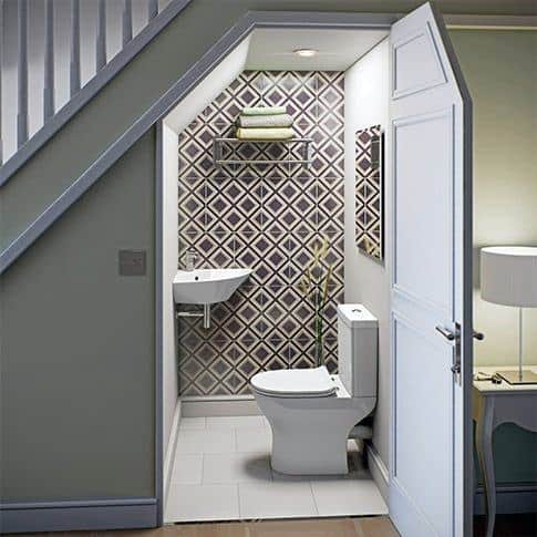 under the stairs powder room with pattern wall tiles
