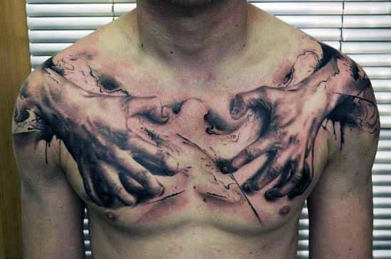 Chest tattoo of hands tearing through the skin