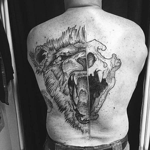 Back tattoo of a roaring lion, half alive and half skull, in black and white