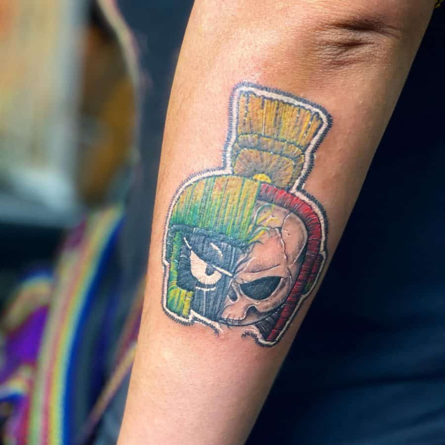 Patch-style embroidered tattoo of Marvin the Martian, blending his iconic green helmet with a skeletal half-face for a unique design.