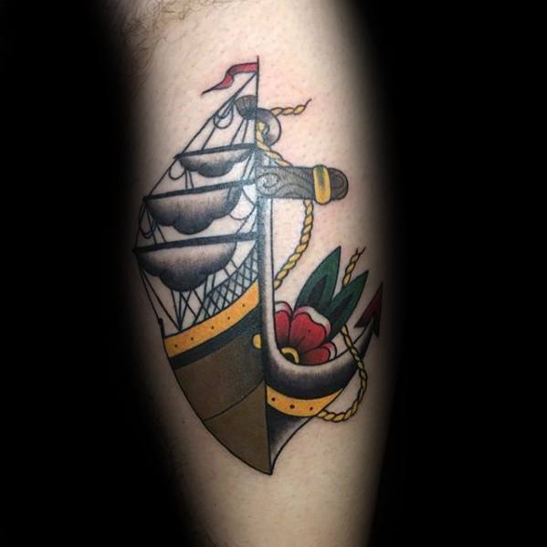 A traditional tattoo of a sailboat on a person's skin featuring an anchor and vibrant red flower