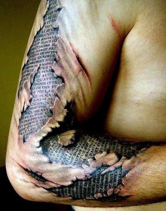 Realistic tattoo of torn skin revealing Latin text on an upper arm