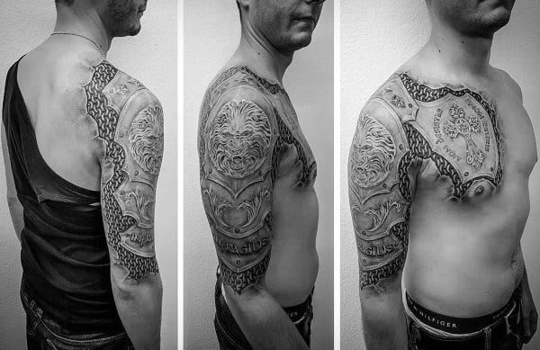 Full upper arm and chest tattoo designed like ornate medieval armor, featuring lion heads, chains, and intricate detailing for a plated armor look.