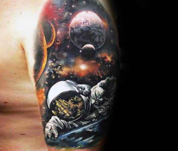 Tattoo of an astronaut floating in space with planets and stars in the background