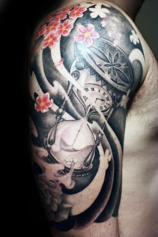 Half-sleeve tattoo featuring a shaded hourglass, pocket watch, swirling wind patterns, and pink cherry blossoms in a Japanese-inspired design