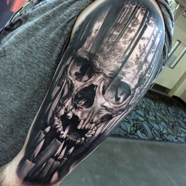 Realistic skull tattoo with dark shadows on a person's upper arm