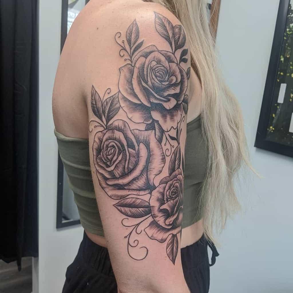 Woman with a half-sleeve tattoo featuring a large black rose on her arm