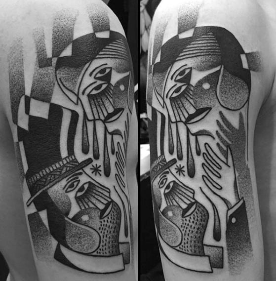 Blackwork Cubist tattoo on the upper arm showing two abstract faces in close interaction, with dotted shading and geometric details.