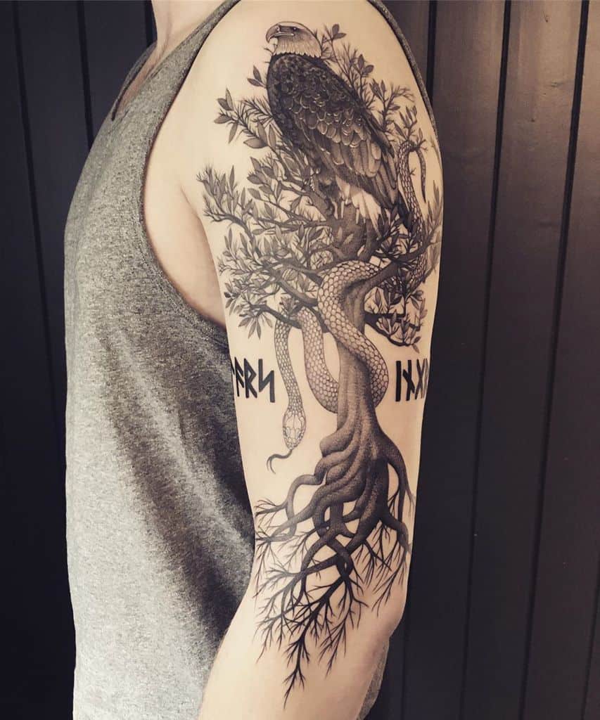 The tattoo features Yggdrasil with an eagle perched in its branches, a serpent winding around the trunk, and Norse runes, symbolizing mythology and balance.