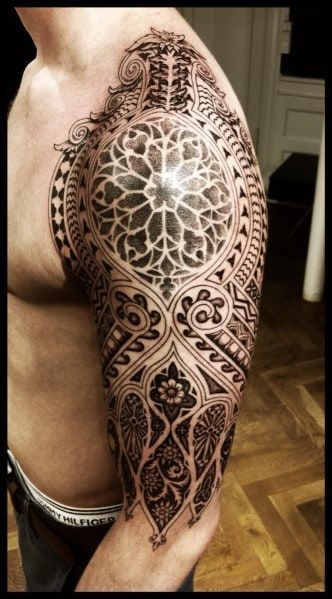 Intricate black and white half-sleeve mandala tattoo on a man's upper arm and shoulder