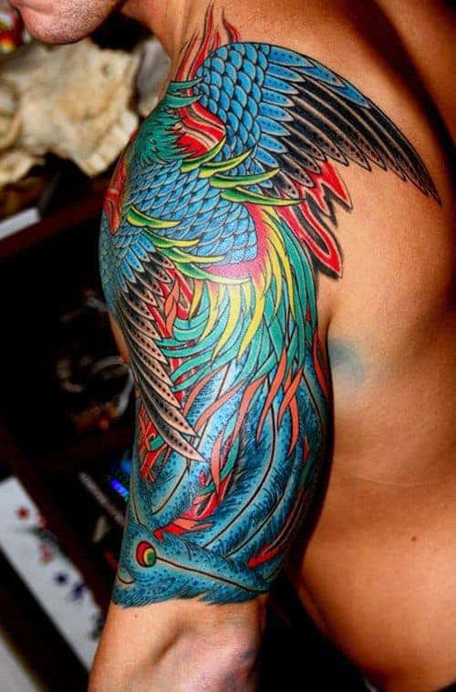 Colorful bird tattoo covering a person's shoulder and upper arm