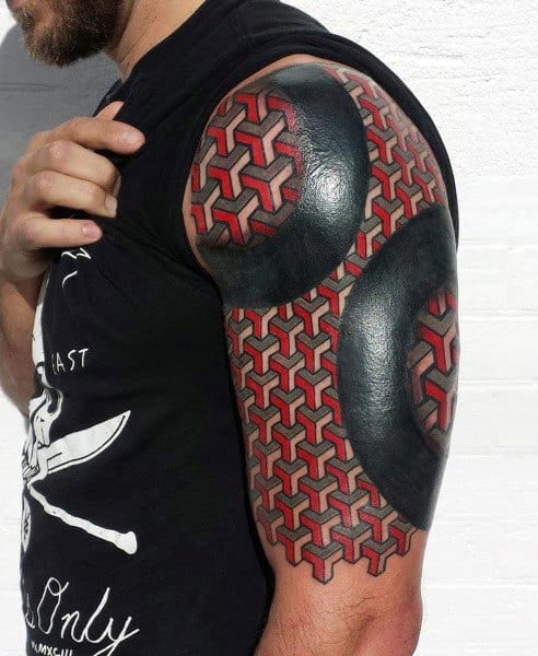 Man’s arm with geometric red and black tattoo design covering upper arm and shoulder