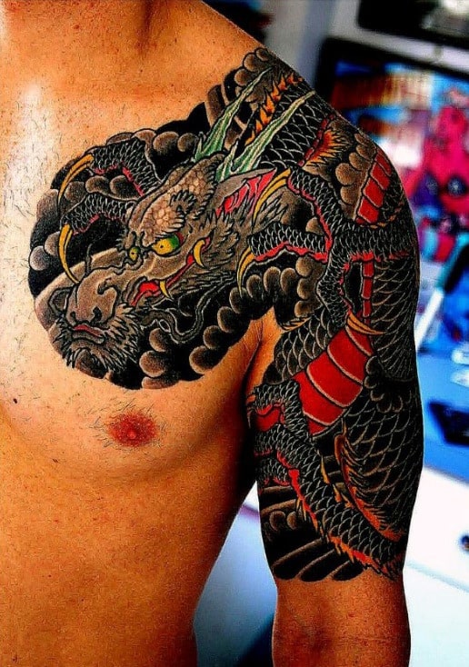 Tattoo of a dragon covering a man's shoulder and upper arm