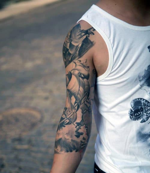 Person with a detailed sleeve tattoo, wearing a white tank top