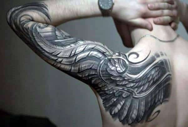 Man with a large, detailed wing tattoo covering his arm and upper shoulder
