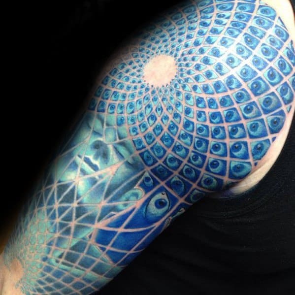 Blue Tool-inspired sleeve tattoo with hypnotic eye patterns forming a radiant spiral, layered with geometric grids and surreal textures.