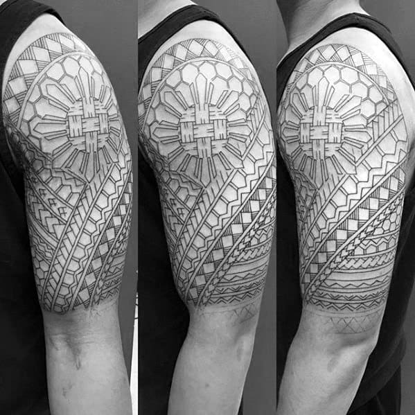 Filipino sun tattoo in fine line style with geometric rays and tribal patterns, wrapping around the upper arm in a clean half-sleeve layout.