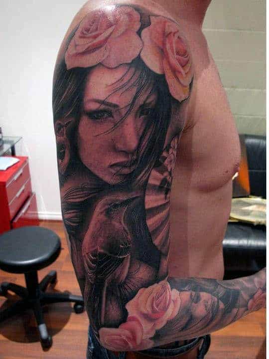 Arm tattoo of a woman's face with a flower crown on an individual