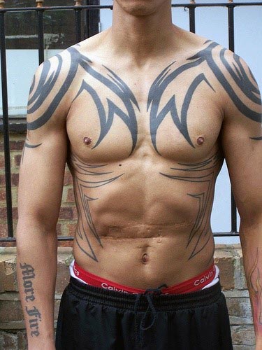 Man with large tribal tattoos on his chest and arms