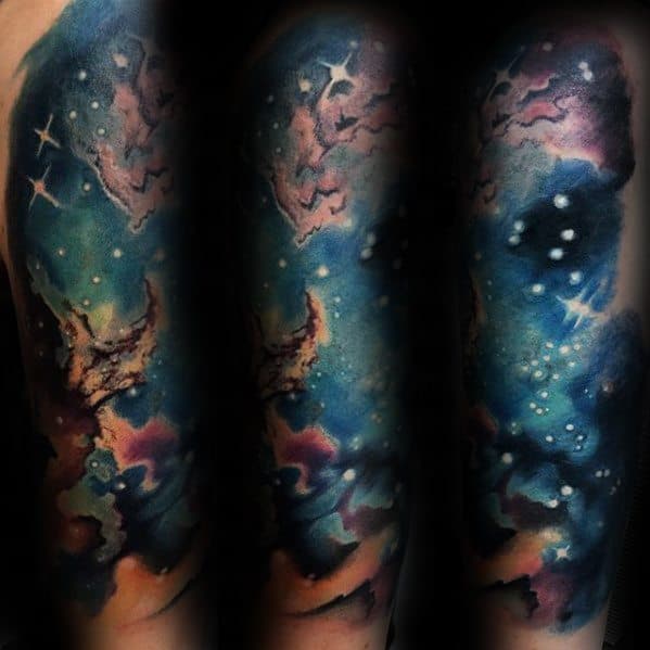 Colorful nebula tattoo with stars and a galaxy theme on an arm