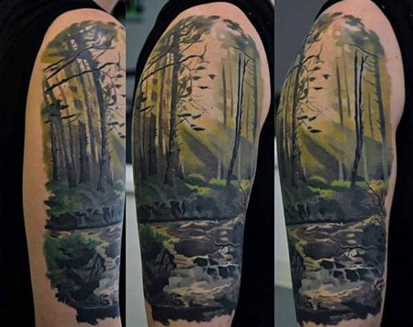 Forest and river scene tattoo on upper arm, showing trees, water, and fish