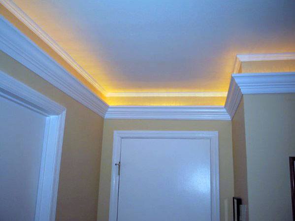Cozy hallway with warm yellow LED crown molding lighting, creating a welcoming atmosphere
