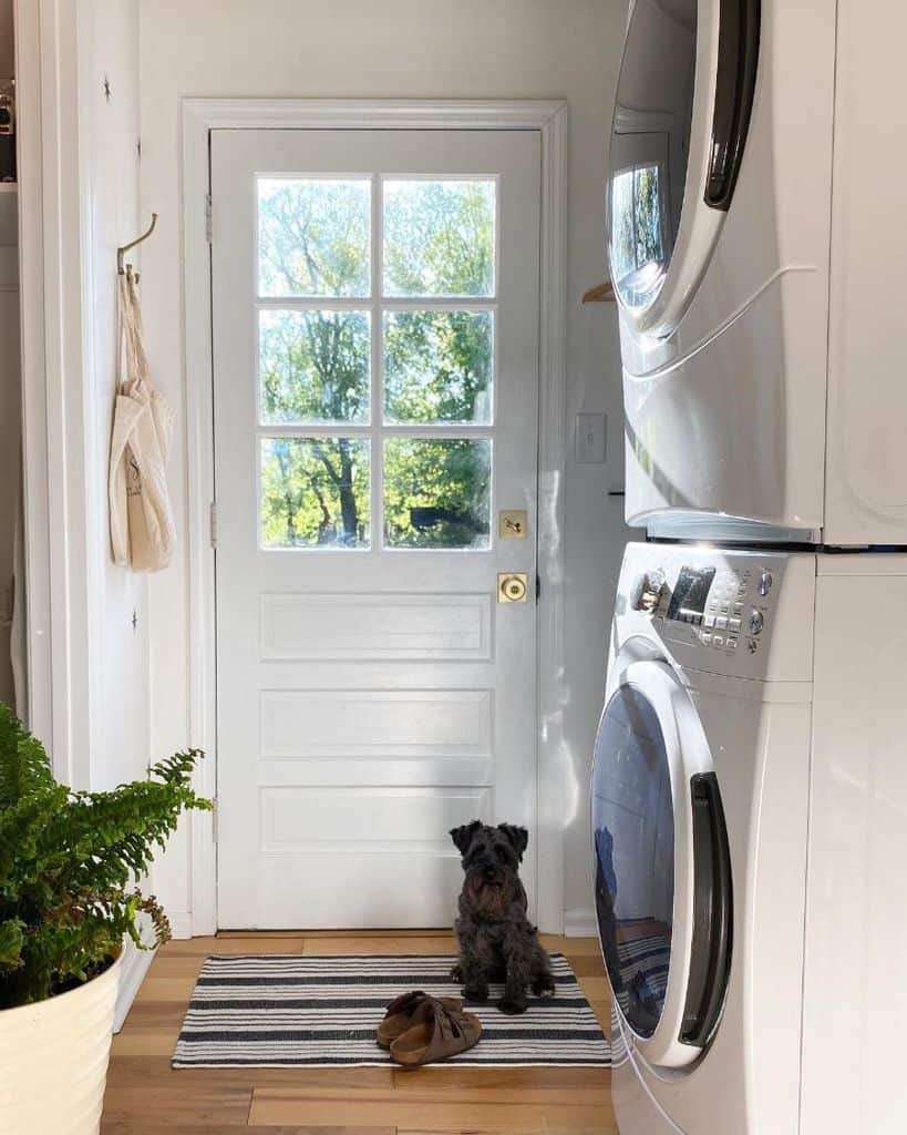 hallway laundry room stacked washer and dryer