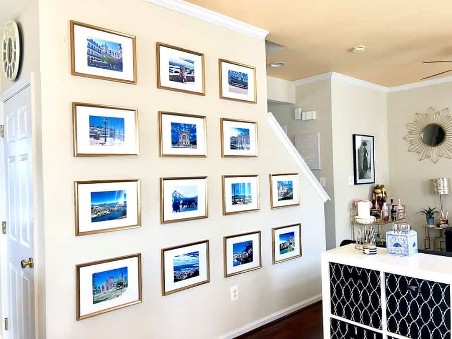 gold framed images on hallway wall