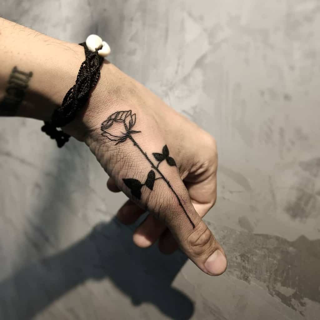 Hand with a black rose tattoo