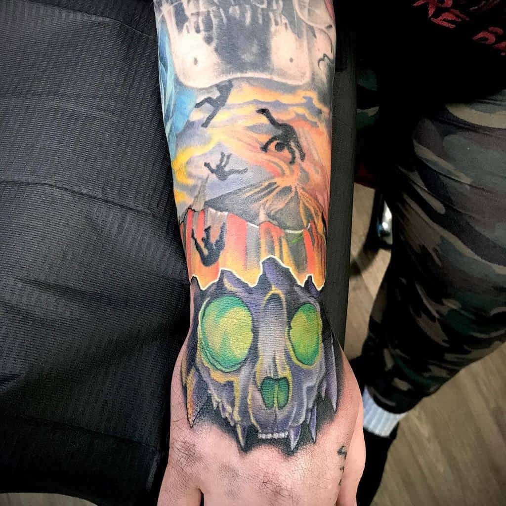 Tattoo featuring a bone mask with green eyes below a scene depicting people falling from the sky, intertwined with the intricate lines of a cat skull