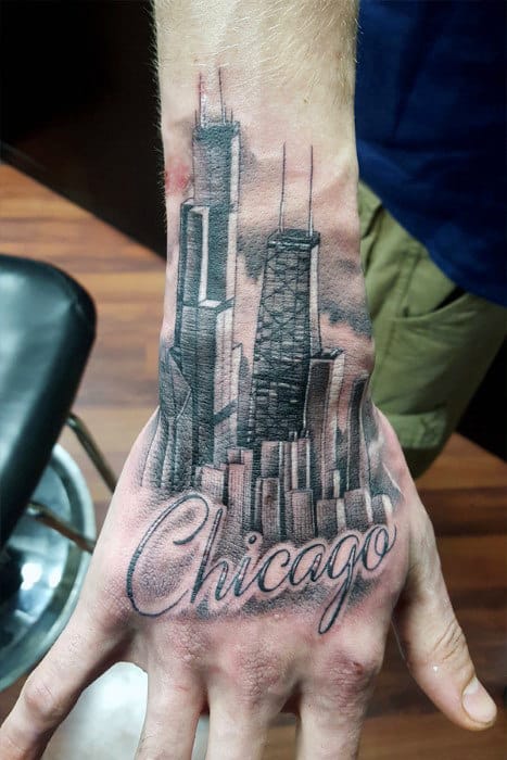 Hand Tattoo Of Chicago Word With City Skyline Buildings In Background On Man