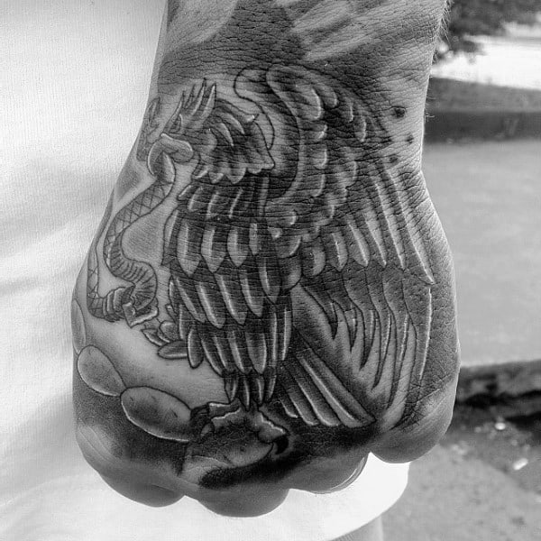 Hand Tattoo Of Mexican Eagle On Male