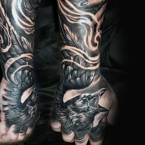 Hand Tattoo Of Realsitic Crow On Male