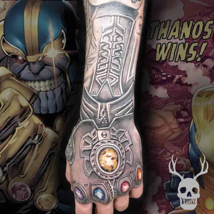 A detailed black and gray tattoo of the Infinity Gauntlet, showcasing the intricate design of the gauntlet and the Infinity Stones