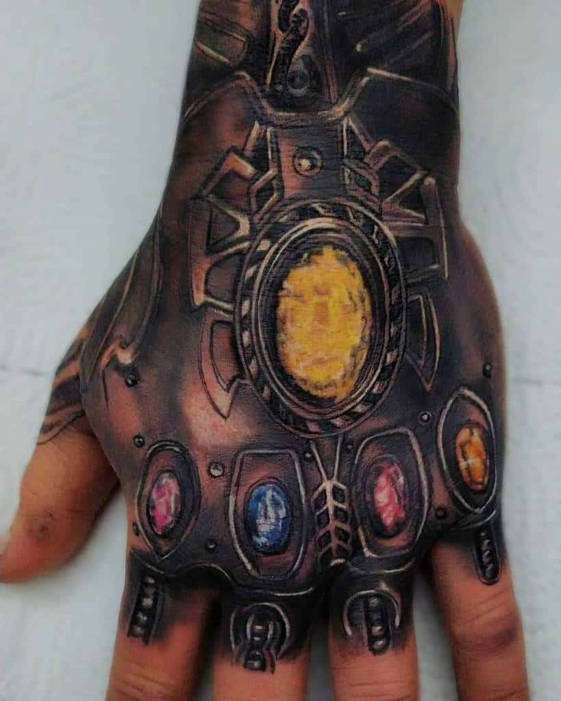 Detailed tattoo of the Infinity Gauntlet, featuring realistic shading and vibrant colors for the Infinity Stones, with intricate detailing on the gauntlet's design