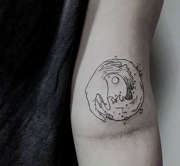 Simple tattoo of a hand cradling a swirling wave on an inner forearm