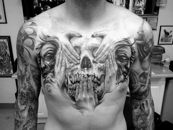 Hands Over Skull Guys Upper Chest Tattoo Designs