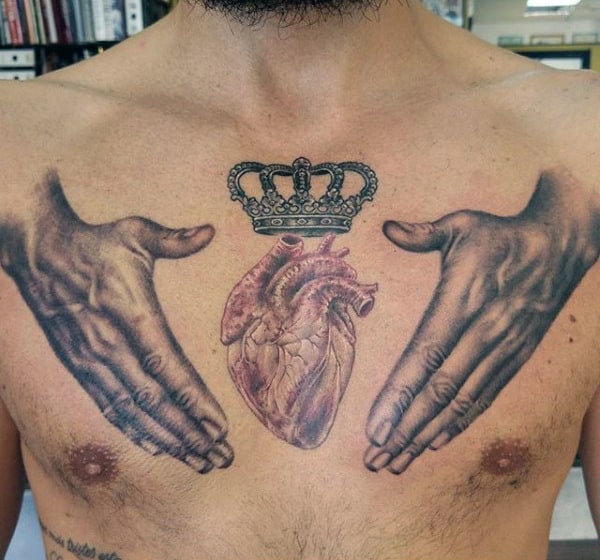 Hands Protecting Crowned Heart Tattoo On Chest