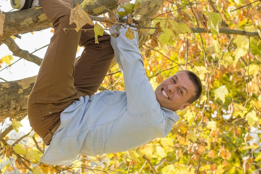 handsome man hanging from the tree