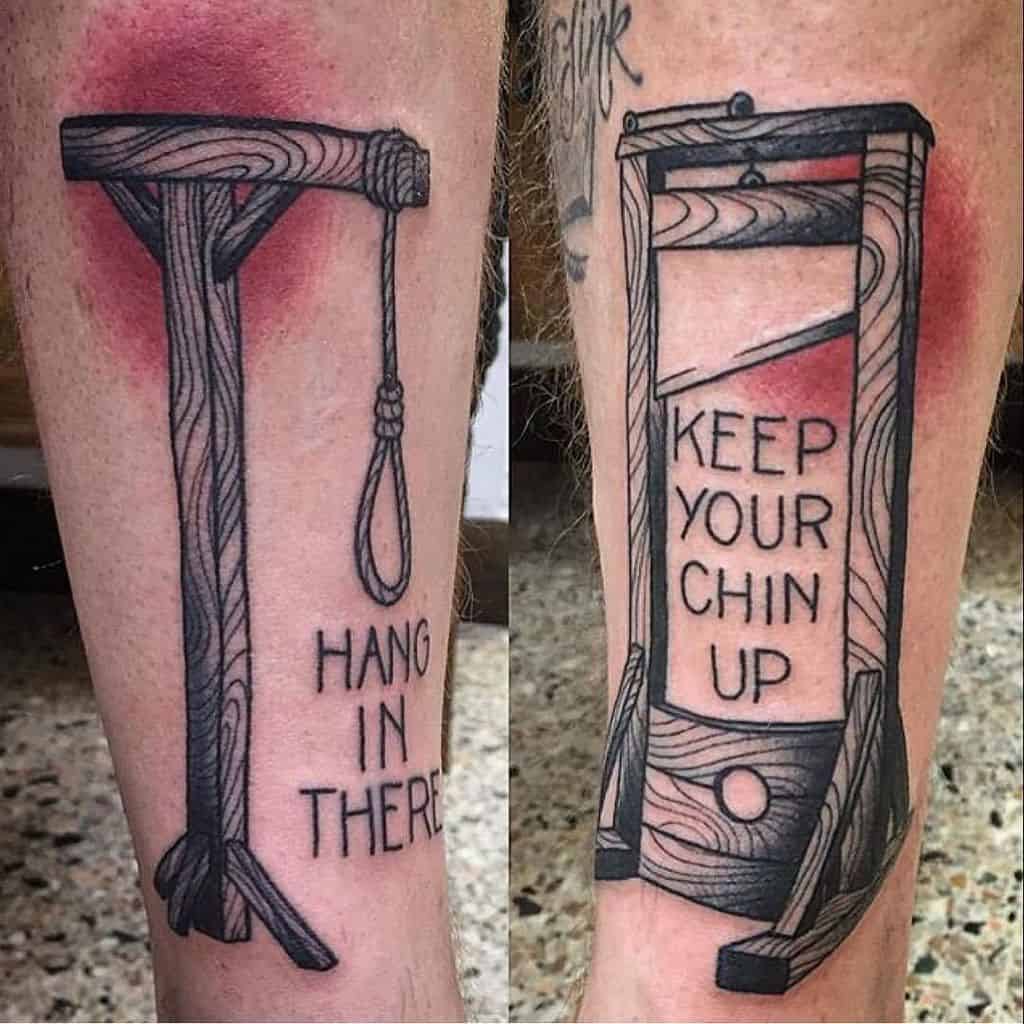 Two dark humor tattoos; one of a gallows with 'Hang in there,' and another of a guillotine with 'Keep your chin up,' both in a woodcut style.