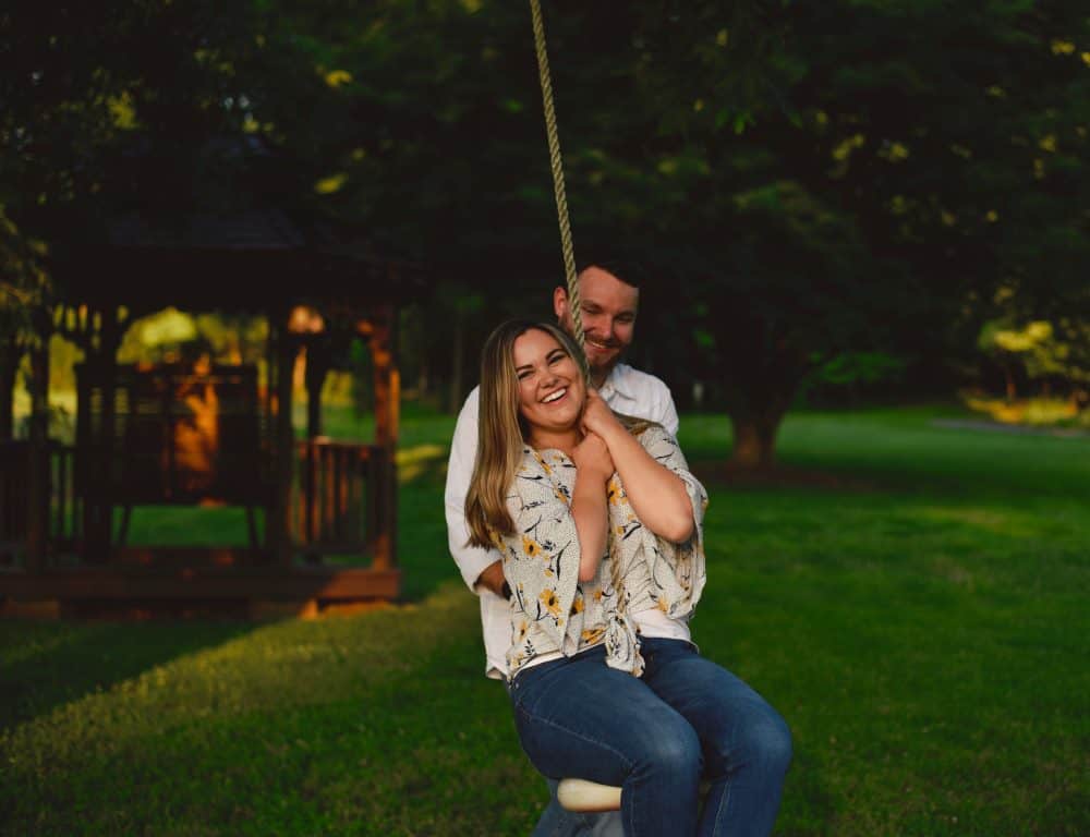 happy couple swing at the park