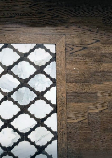 patterned marble entryway tiles with wooden border