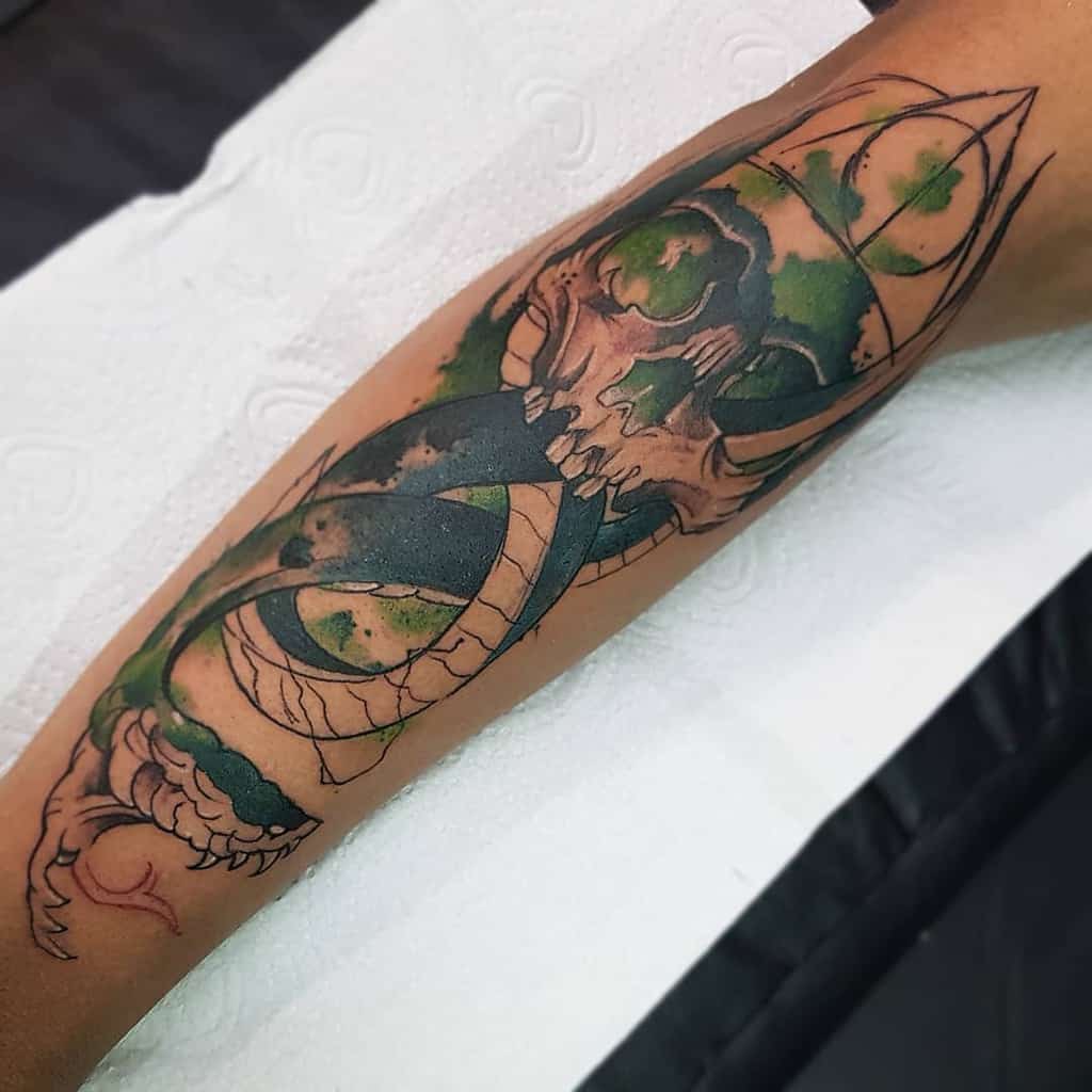 Dark Mark tattoo featuring a skull and serpent with green and black shading, inspired by Voldemort's symbol in Harry Potter