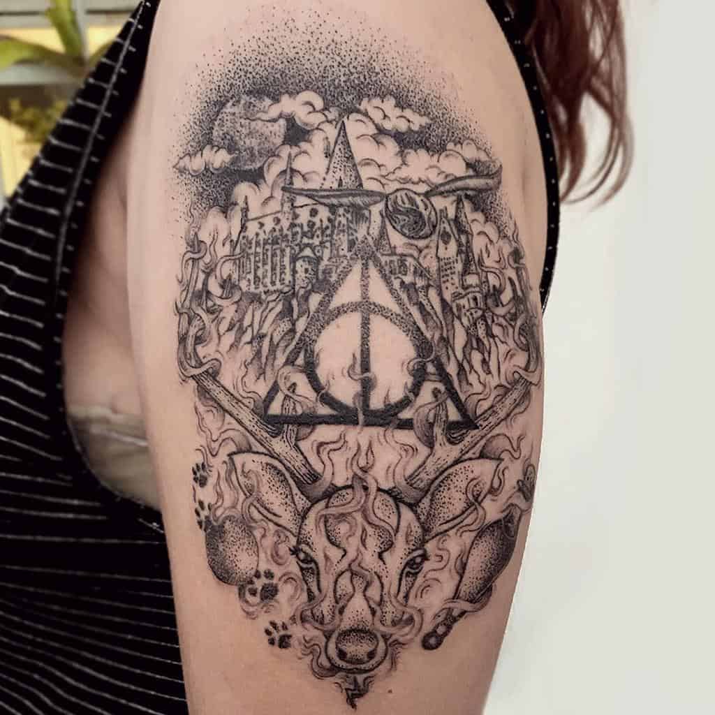 Intricate tattoo featuring the Deathly Hallows symbol surrounded by iconic Harry Potter elements