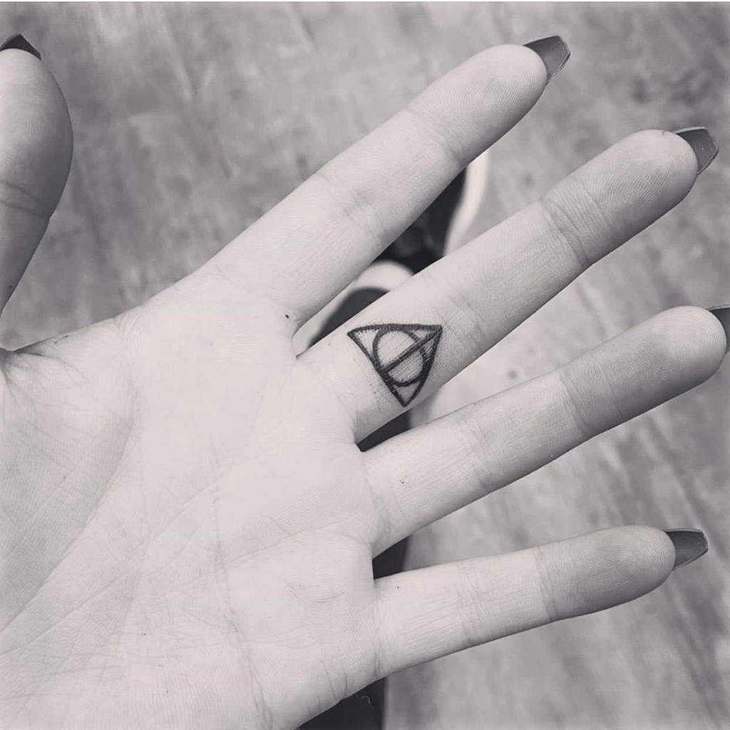A minimalist Deathly Hallows tattoo showcasing a subtle and elegant Harry Potter-inspired design