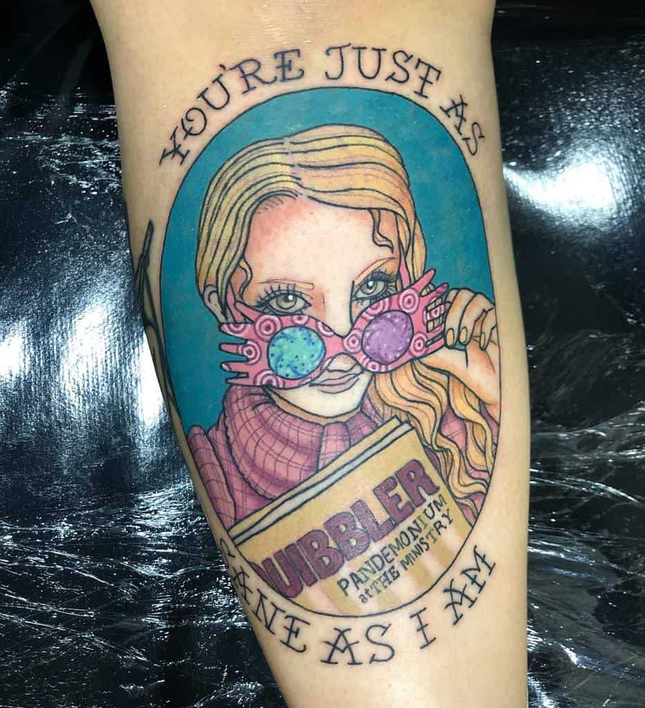 Vibrant Luna Lovegood tattoo from Harry Potter, featuring her signature Spectrespecs, a copy of The Quibbler, and the quote 'You're just as sane as I am'